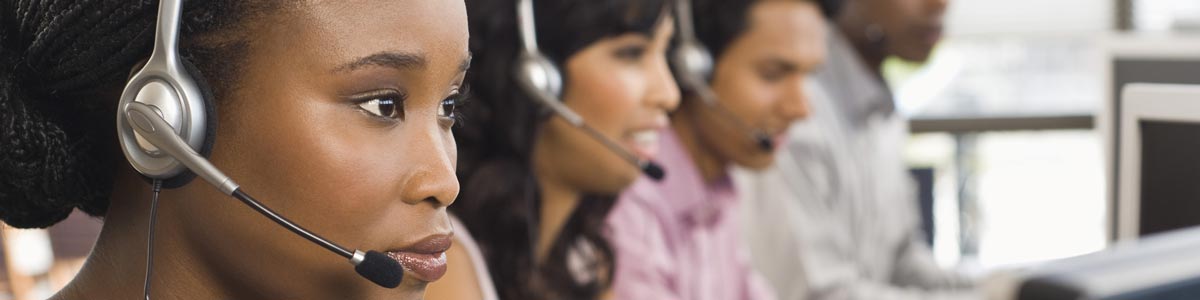 Call centre representatives with two young females and a male speaking through headset