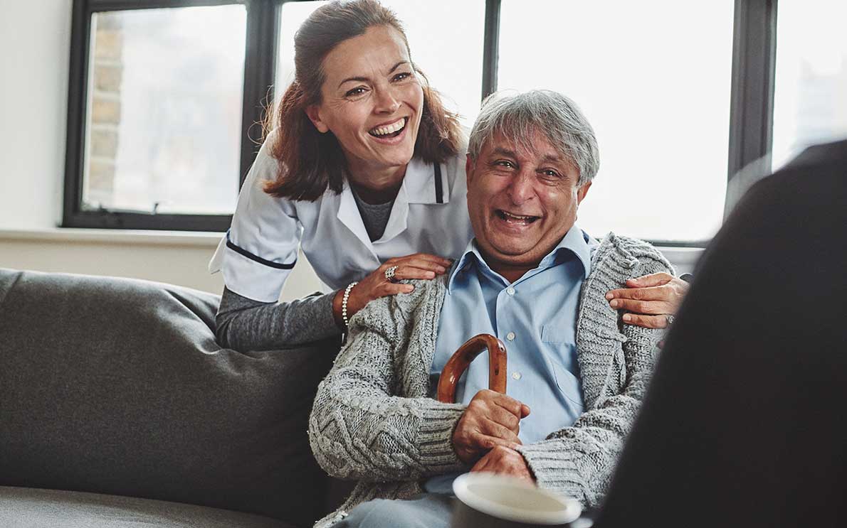 Smiling female healthcare worker and elderly gentleman